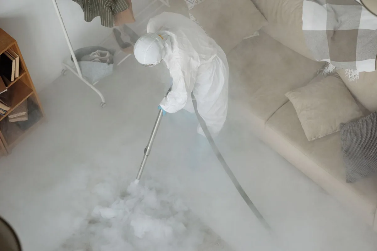 Biohazard cleanup technician in protective equipment, Redland, TX